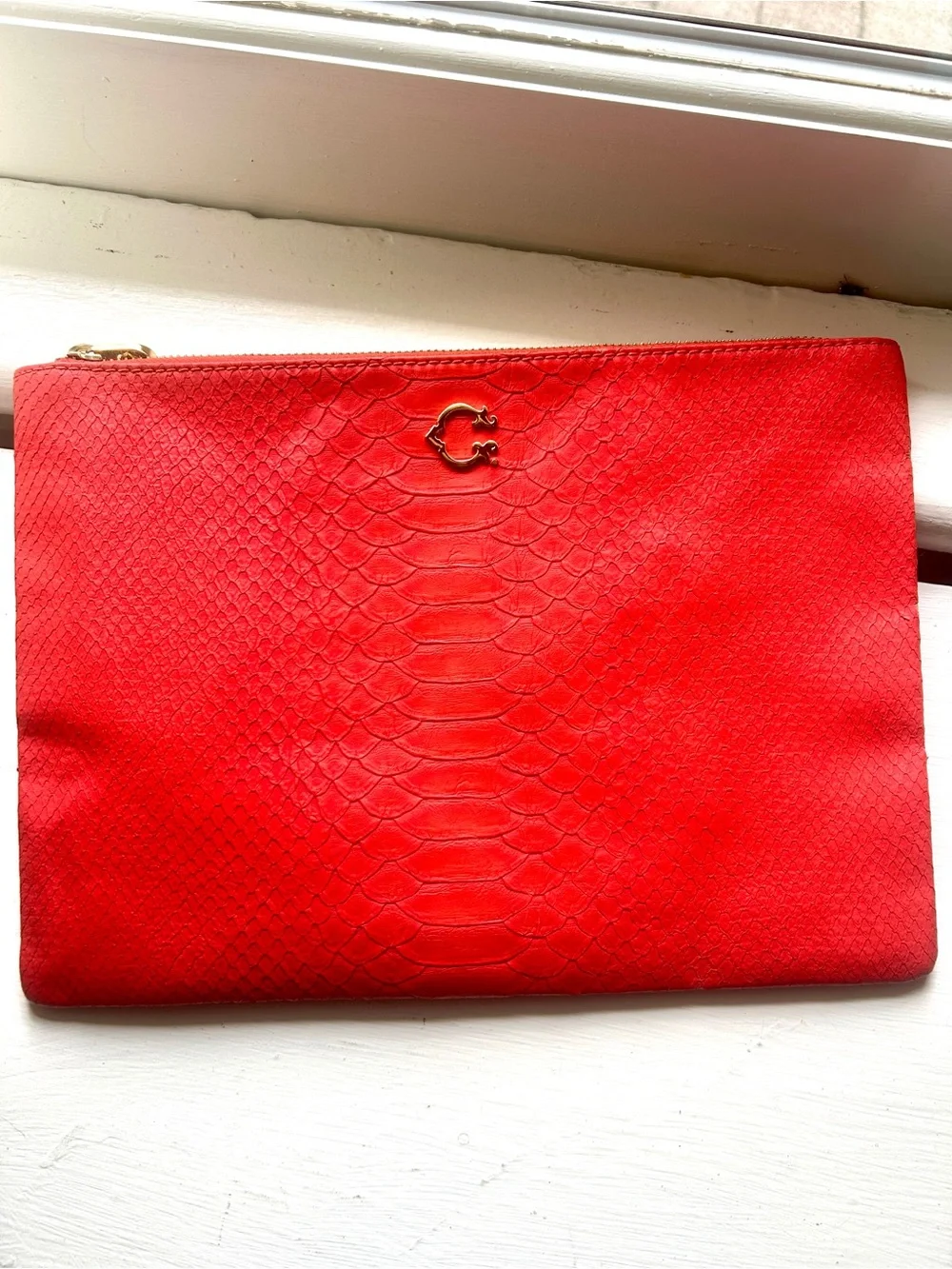 C. Wonder Clutch Orange Red Embossed Print Zip Close with Gold C Emblem